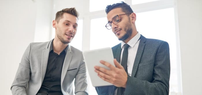 two entrepreneurs using digital tablet