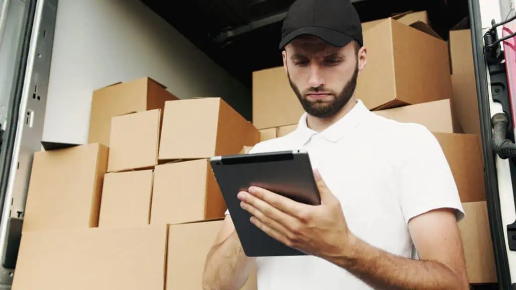 Man in white polo shirt using a tablet computer