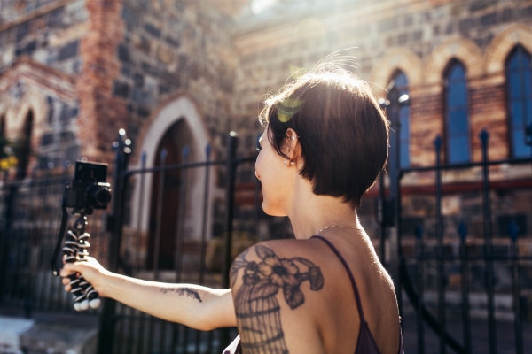 short haired woman camera